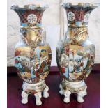 A pair of moriage Satsuma vases, set on five legged bases