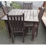 A 3' 1 1/2" slatted teak garden table - sold with a set of four lath back standard chairs to match