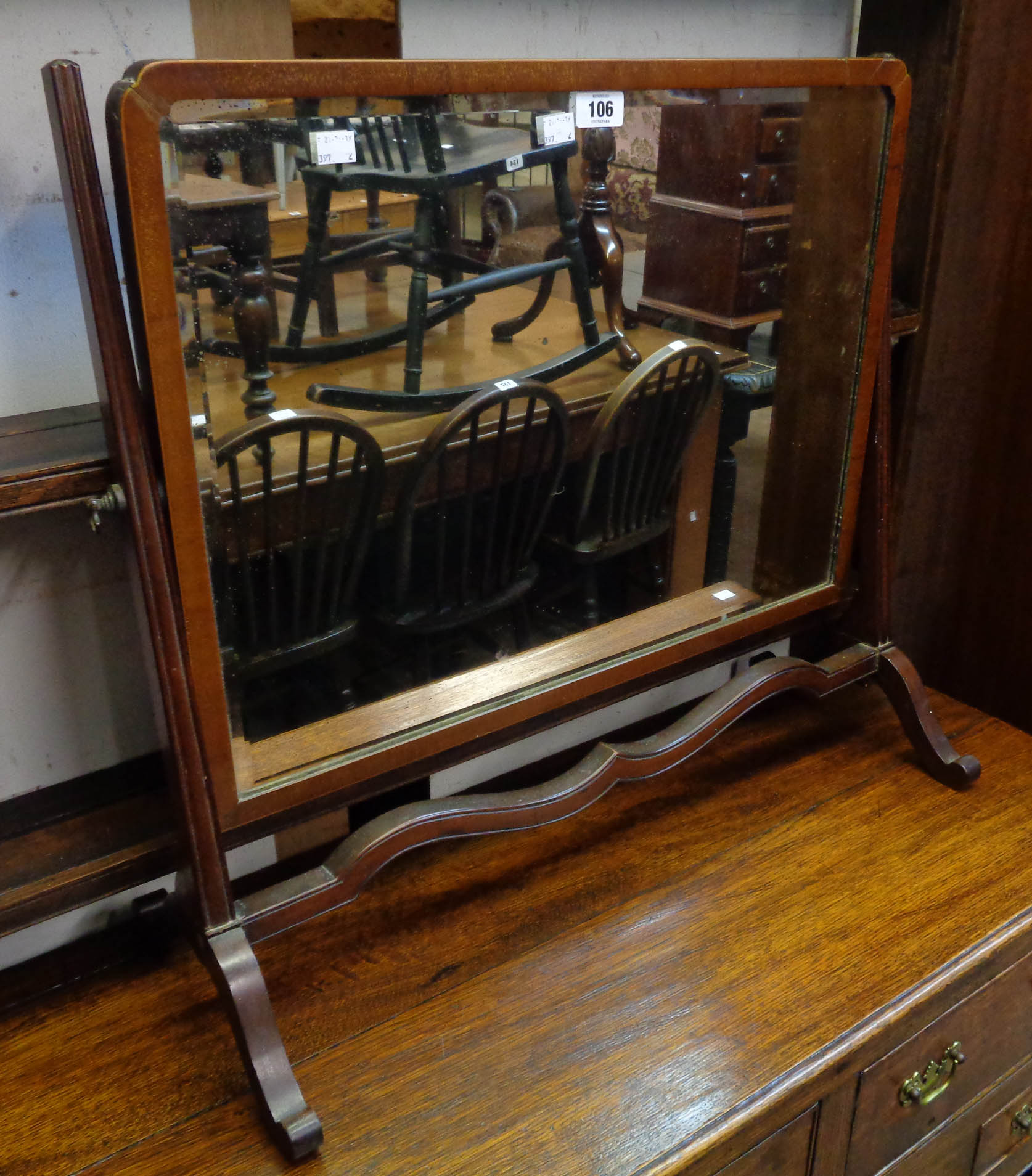 An Edwardian mahogany framed dressing table mirror, set on slender swept supports