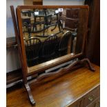 An Edwardian mahogany framed dressing table mirror, set on slender swept supports