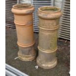 A pair of 34 1/2" antique terracotta chimney pots