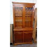 A 3' 1" reproduction yew two part cabinet with illuminated display shelves to top, over a base