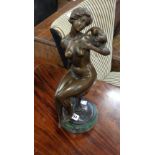 A bronzed seated nude woman sat on a pedestal with socle base - height 15"