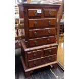 A 16 1/2" reproduction mahogany and cross banded chest of two short and three long drawers over