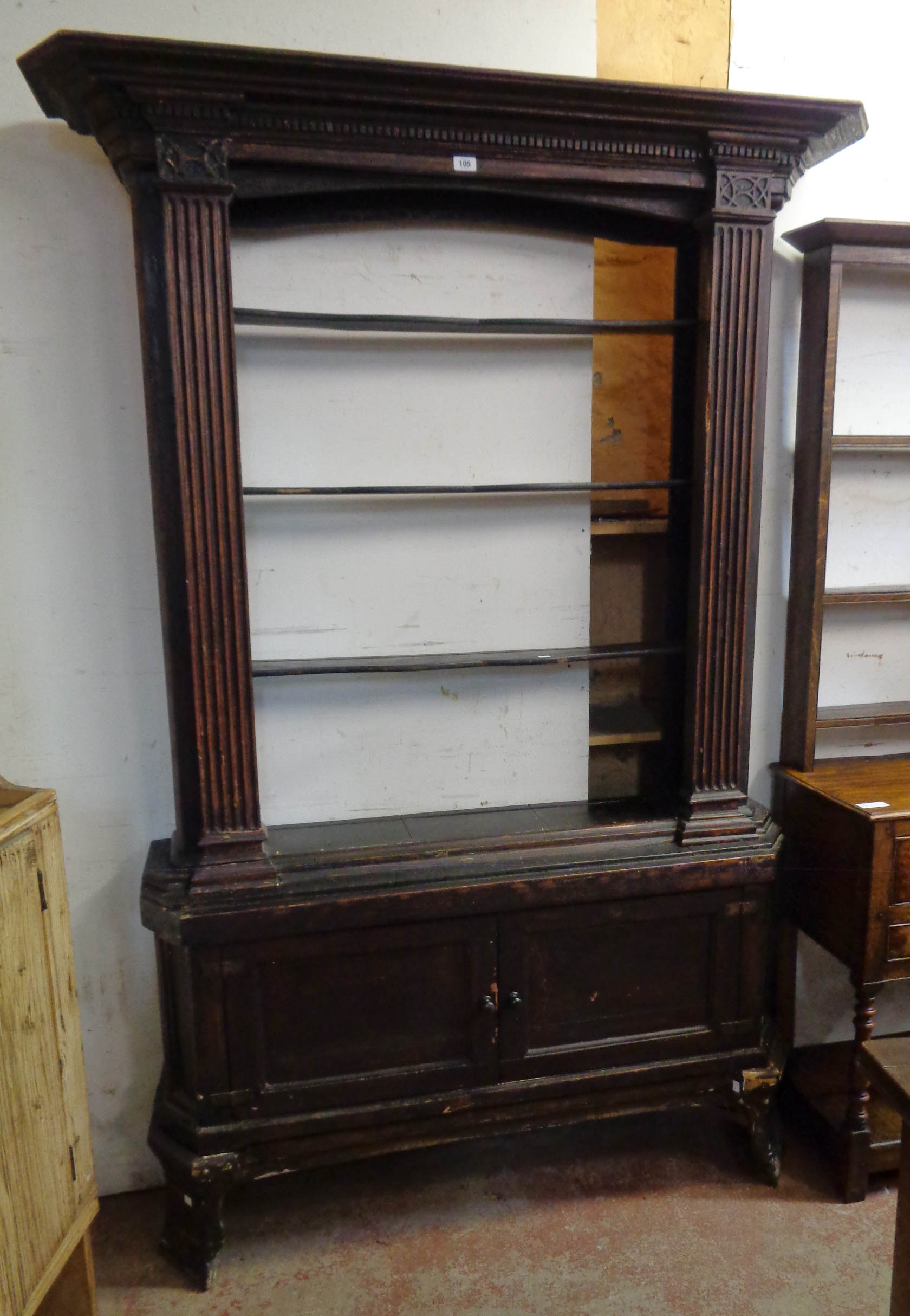 A 4' 9" antique stained mixed wood dresser with moulded dentil cornice, blind fretwork and