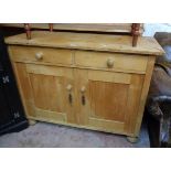 A 36 1/4" waxed pine dresser base with two short drawers and pair of panelled cupboard doors