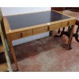 A 3' 9" vintage polished wood writing table with inset top and three frieze drawers, set on