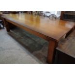 A 9' 20th Century polished oak dining table with sectional top, set on moulded square legs