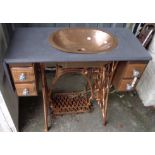 A 34" later painted washstand formed from a Singer treadle sewing machine base, with hammered copper