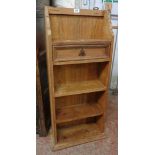 A 17 1/2" pine four shelf open bookcase with shaped top, single drawer and moulded base