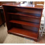 A 3' 1" reproduction mahogany three shelf open bookcase, set on bracket feet - sliding glass doors