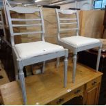 A pair of later painted rail back standard chairs with calico upholstered drop in seats, set on