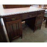 A 3' 9" Edwardian walnut kneehole desk with later inset top, central drawer, four drawers to one