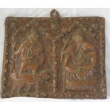 An antique ethnographic copper on wood panel with repoussé and engraved decoration depicting two