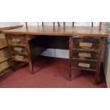 A 5' 1940's stained oak office desk with pair of slides, four short drawers and deep file drawer -