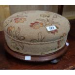 A Victorian mahogany circular footstool with tapestry upholstered top, set on squat bun feet