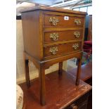 A 17 1/2" 20th Century mahogany bedside chest of three long drawers, set on chamfered square legs