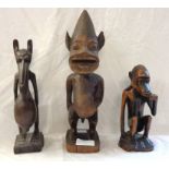 Three pieces of African carved wood ethnographica comprising two fertility figures and a monkey