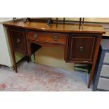 A 4' 6" late 19th Century mahogany and strung break front sideboard with serpentine frieze drawer