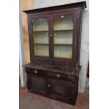 A 4' 4" antique grained pine Cornish dresser with moulded cornice, shelves enclosed by a pair of