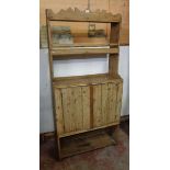 A 35" mid 19th Century Irish naive waxed pine dresser with plate rack, surface, two doors and open