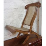 A hardwood framed campaign style folding chair with rattan back and seat panels - sold with a