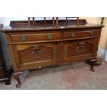 A 5' 6" Edwardian polished walnut bow front sideboard with low raised back, two frieze drawers and