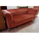 A 6' late Victorian single drop-end Chesterfield settee with old rose button back upholstery, set on