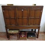 A 4' 6 1/2" 20th Century Waring & Gillows polished oak side cabinet with three panelled cupboard