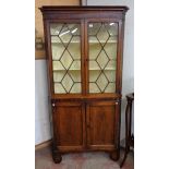A 3' 5" Georgian Welsh oak two part corner cabinet comprising astragal glazed top section and