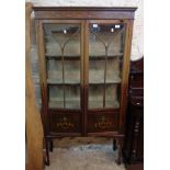 A 36" Edwardian mahogany display cabinet with painted floral swag decoration and remains of material