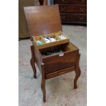 A 1930's polished oak lift-top work box with drawer under and some contents - cantilever a/f