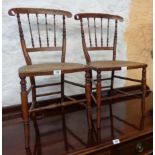 A pair of Victorian stained wood framed bedroom chairs with slender spindle backs and rattan seat