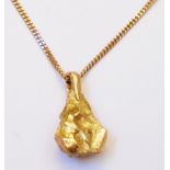 A marked 9ct. solid yellow metal stylised bottle shaped nugget pendant, on Balastra marked 375