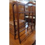 An Edwardian walnut and strung double towel rail