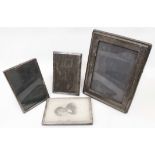 Four silver fronted photograph frames, all with polished oak easel backs