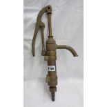 A vintage brass oil drum pump