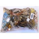 A bag containing a large quantity of assorted costume jewellery