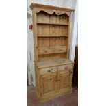 A 34" modern stripped pine two part dresser, the three shelf open plate rack with two frieze drawers