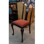 A set of four walnut framed Queen Anne style dining chairs with upholstered drop-in seats, set on