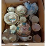 A box containing a quantity of decorative cups and saucers including Minton, Doulton, etc.