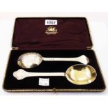 A cased pair of Hamilton & Inches Scottish silver ornate spoons with gilt bowls and raised scroll