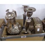 A silver plated ornate coffee pot, a pair of candlesticks, tea strainer, etc.