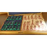 A pink and green chess set with folding board/case
