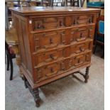 A 3' 2" 1920's oak Jacobean style chest of four long graduated drawers, set on an open barley
