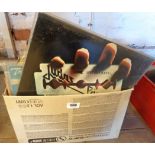 A box containing a collection of vinyl LPs records including 'British Steel' by Judas Priest, '