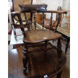 An antique elm smokers bow elbow chair with old repair to back rail and moulded solid seat, set on
