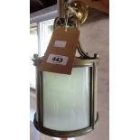 A brass hall lantern with curved and frosted glass panels