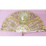 An antique fan with central painted dancers, sequinned decoration and carved gilt mother-of-pearl