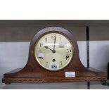 An early 20th Century polished oak cased Napoleon hat mantel clock with eight day chiming movement